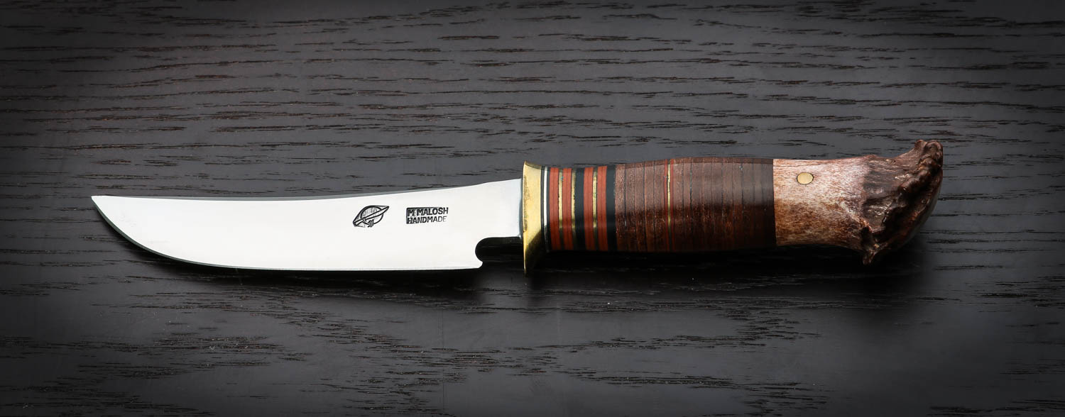 1577303455-malosh-hunter---hand-forged-5----skagel-style-blade-of-01-tool-steel--brass-single-hilt-and-traditional-stacked-leather--brass-and-sambar-s